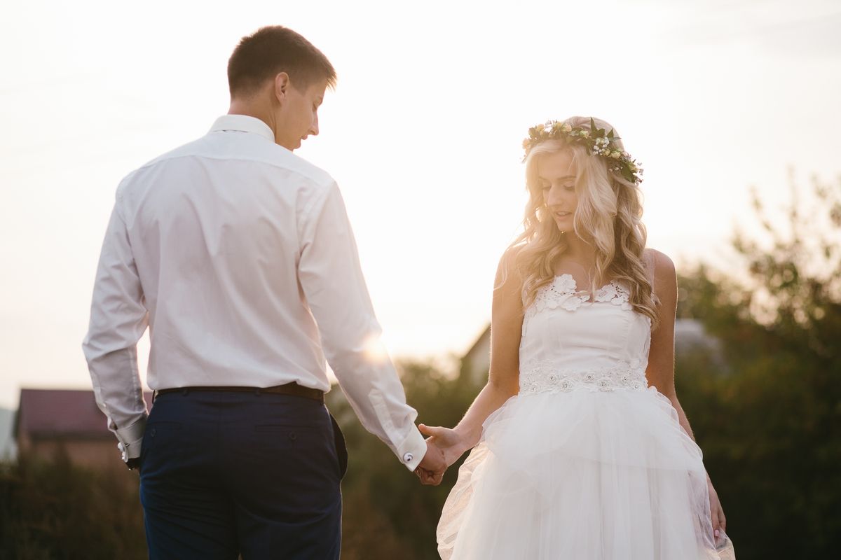 The Essential Wedding Holding Hands Side by Side